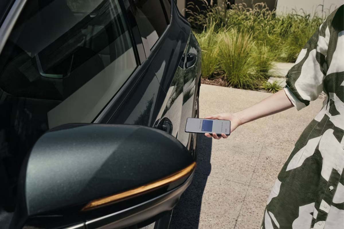 Eine Frau entsperrt ein Hyundai Tucson mit Ihrem Handy